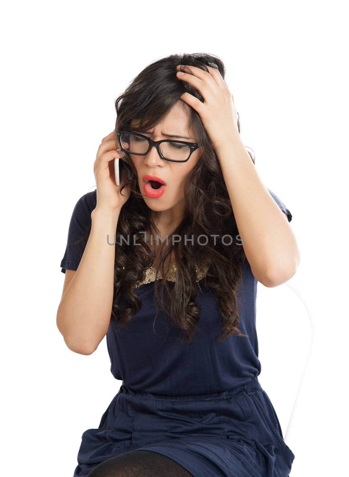 Woman in glasses emotionally speaks on a mobile phone