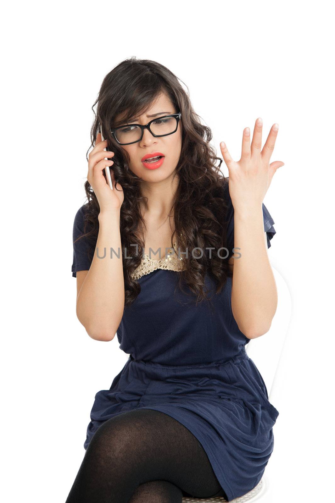 Woman in glasses emotionally speaks on a mobile phone