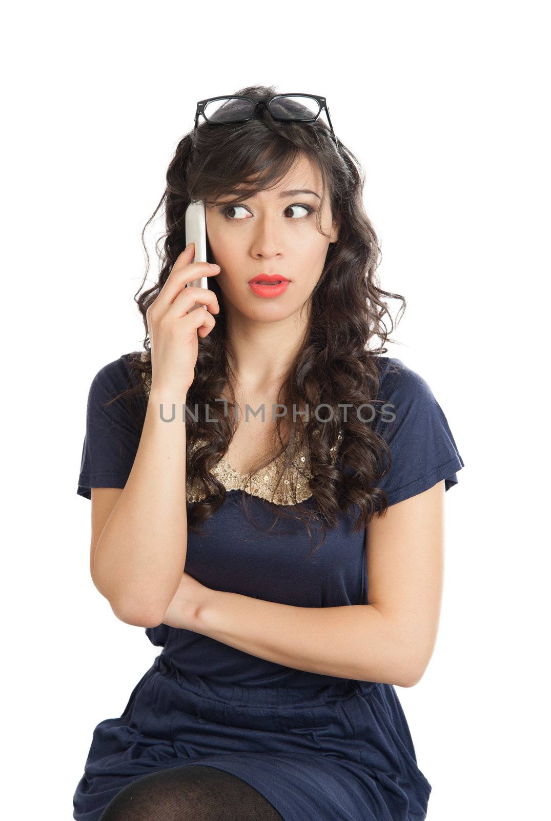 Woman in glasses emotionally speaks on a mobile phone