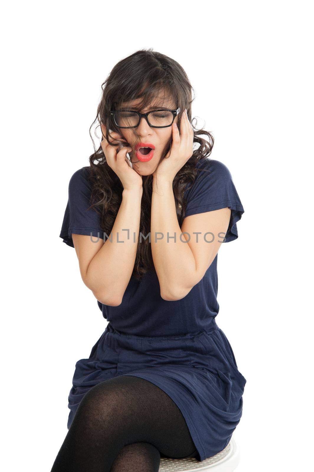 Woman in glasses emotionally speaks on a mobile phone