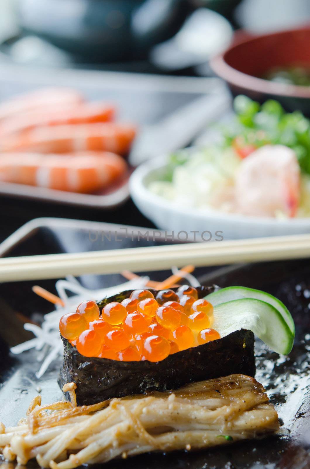 close up Salmon roe sushi  with cucumber  and fried enokitak mushrooms 