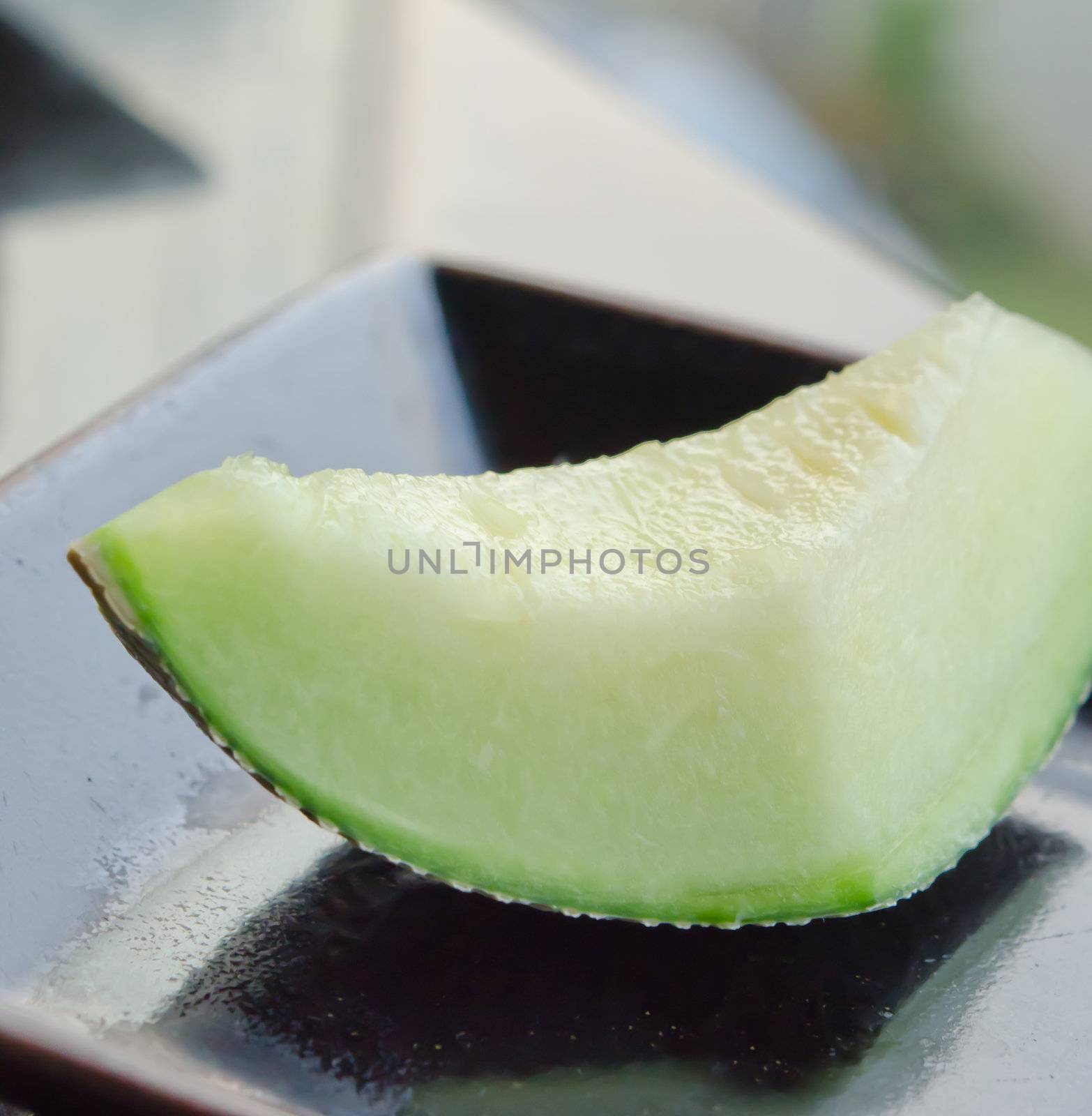 single cantaloupe melon slices  on dish .