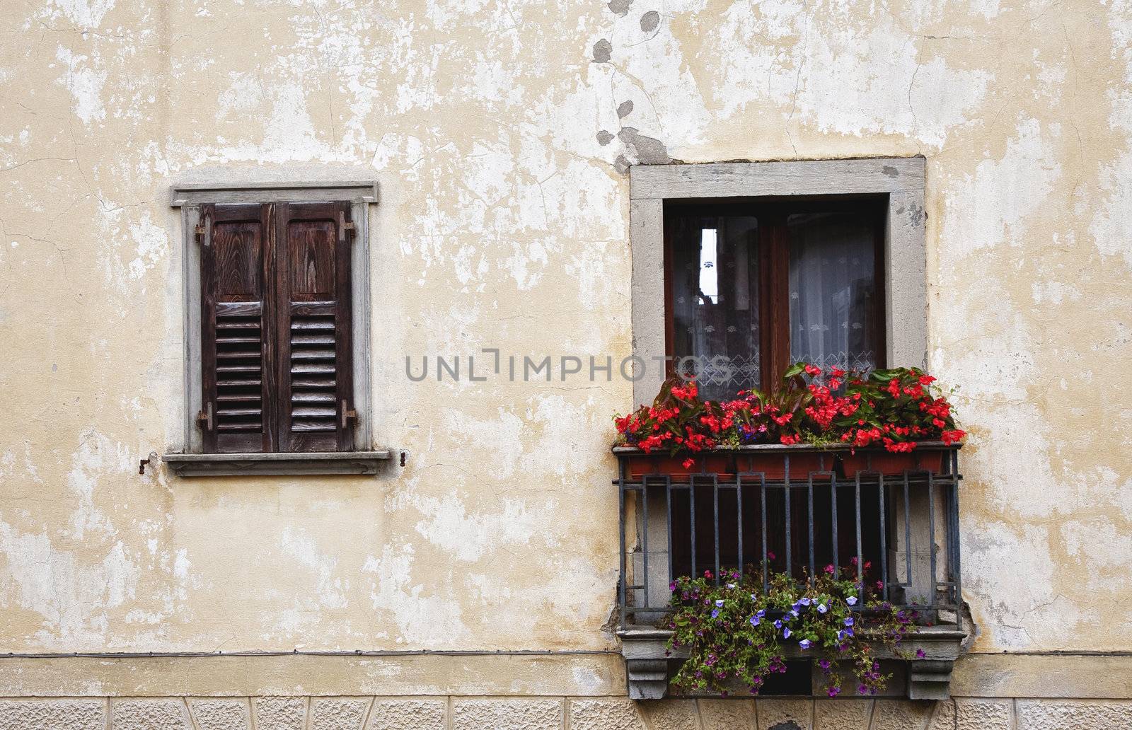 Tiny Italian balcony with flowers at summertime.