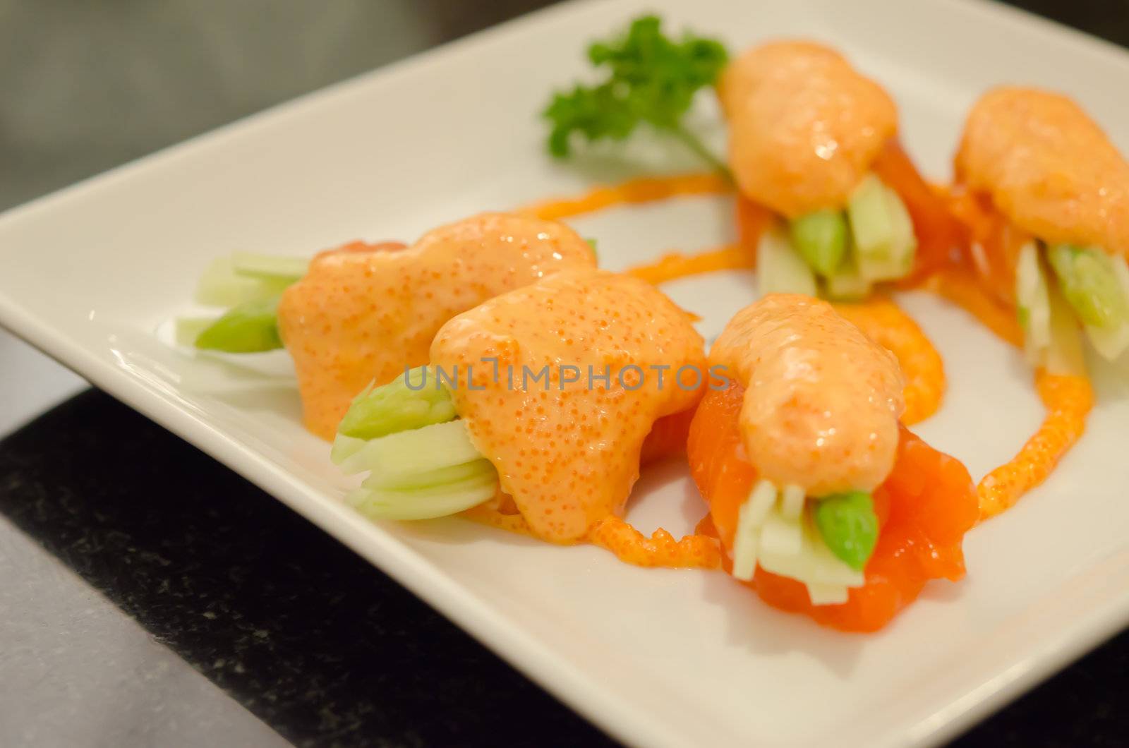 close up  salmon rolls with vegetable on  dish .