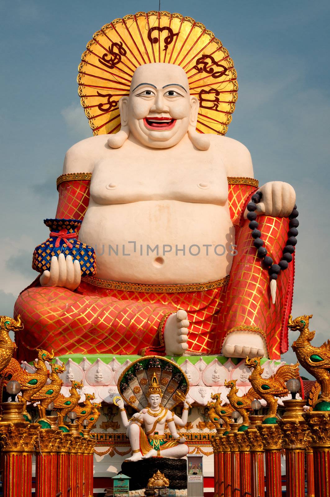 Fat laughing Buddha over blue sky by johnnychaos