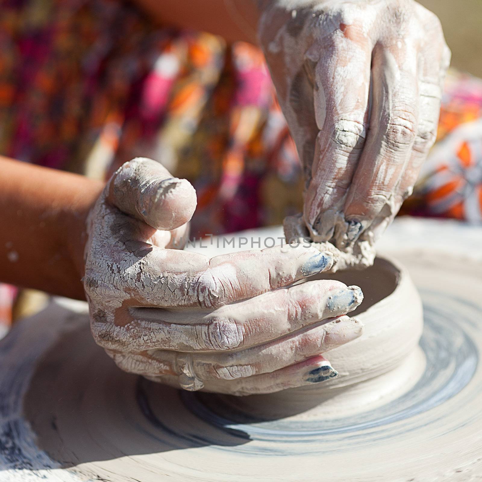 hand on a potter wheel at the fair by jannyjus