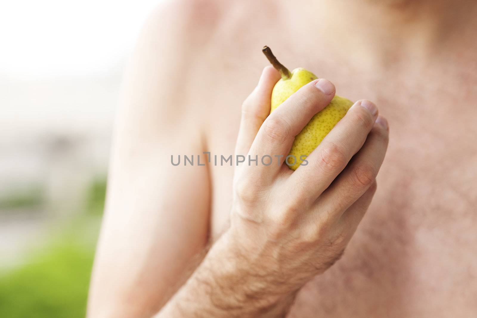 man holding a pear in his hand