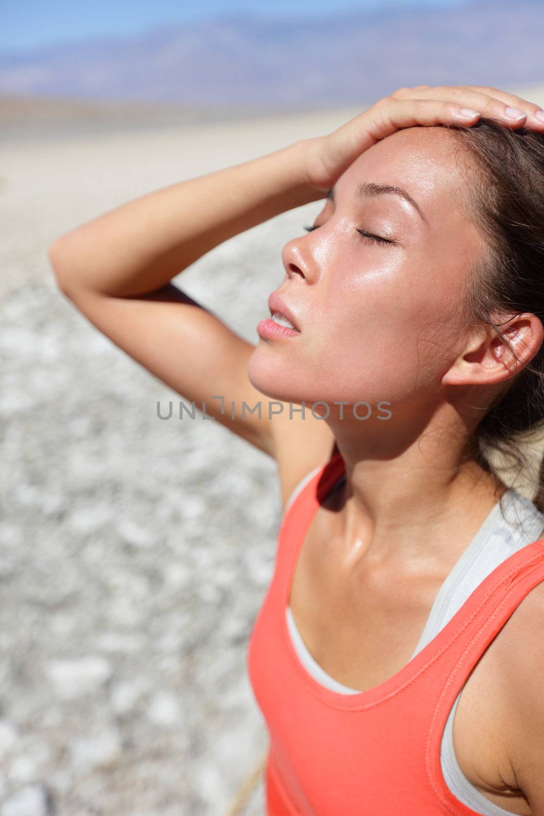 Dehydration thirst concept woman in Death Valley desert. Girl tired and dehydrated close to heat stroke due to high temperature and lack of water.