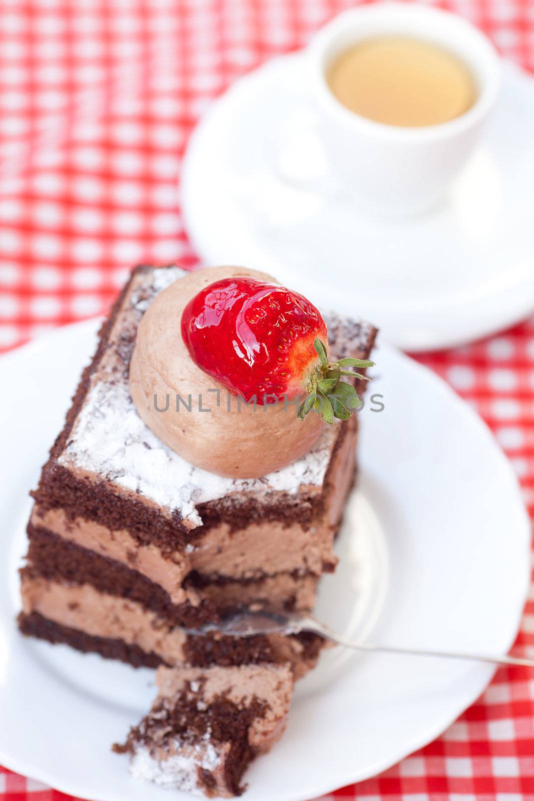 beautiful cake with strawberry and tea on plaid fabric by jannyjus