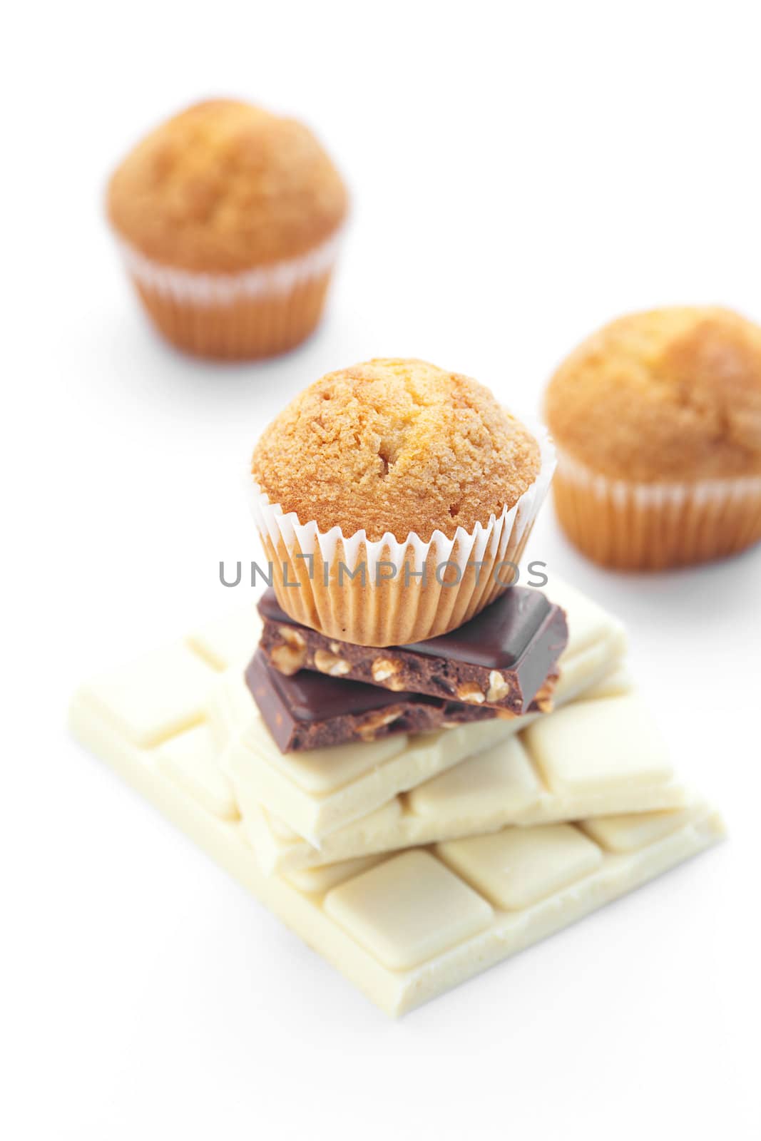 bar of chocolate and muffin isolated on white