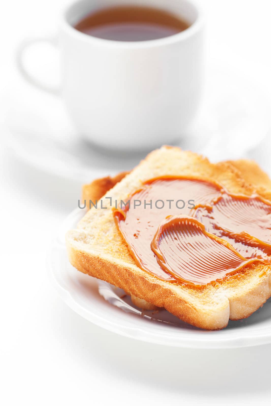 tea and toast with caramel isolated on white