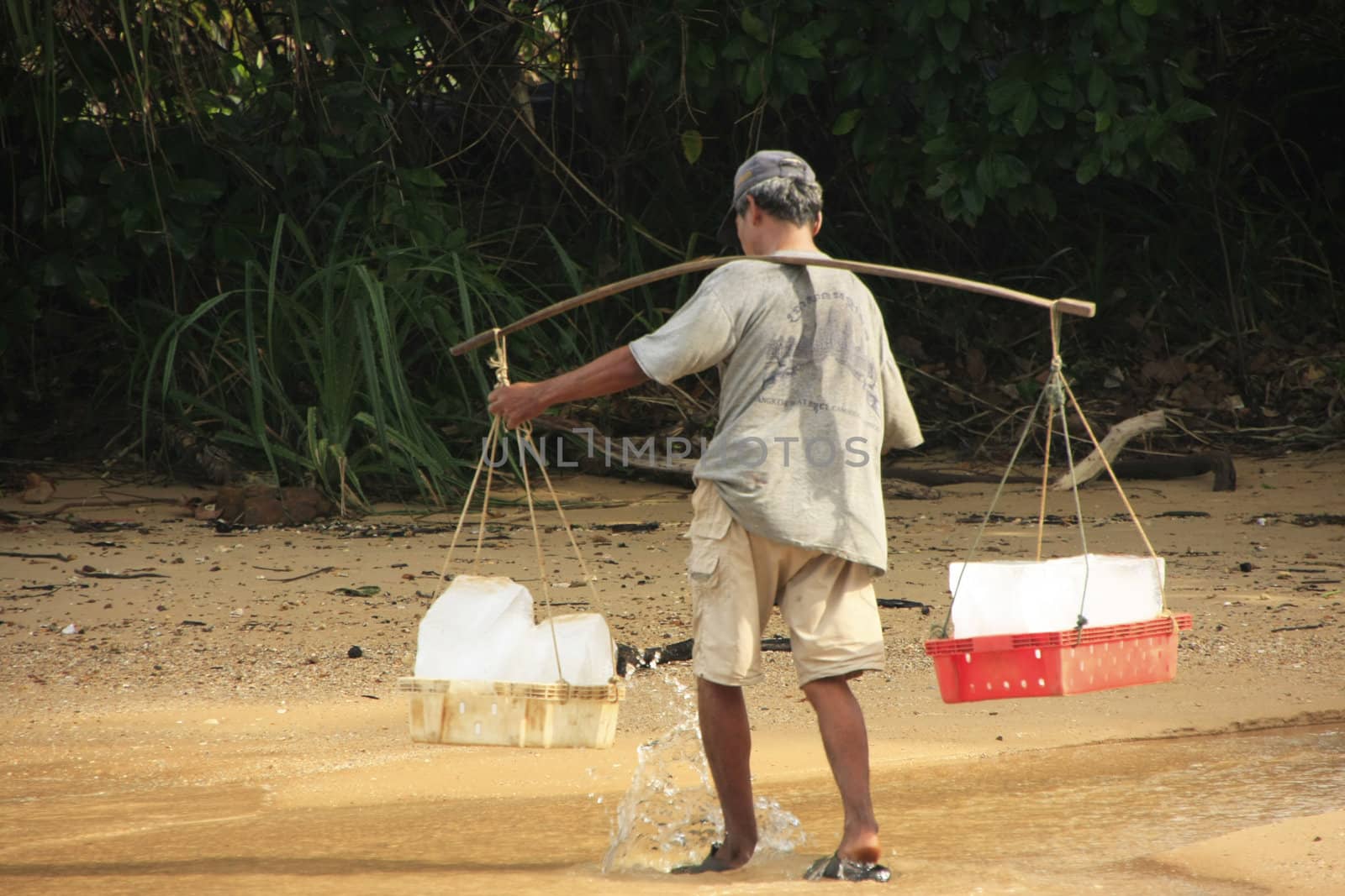 Man carrying ice, Koh Rong Samlon island, Cambodia, Southeast Asia