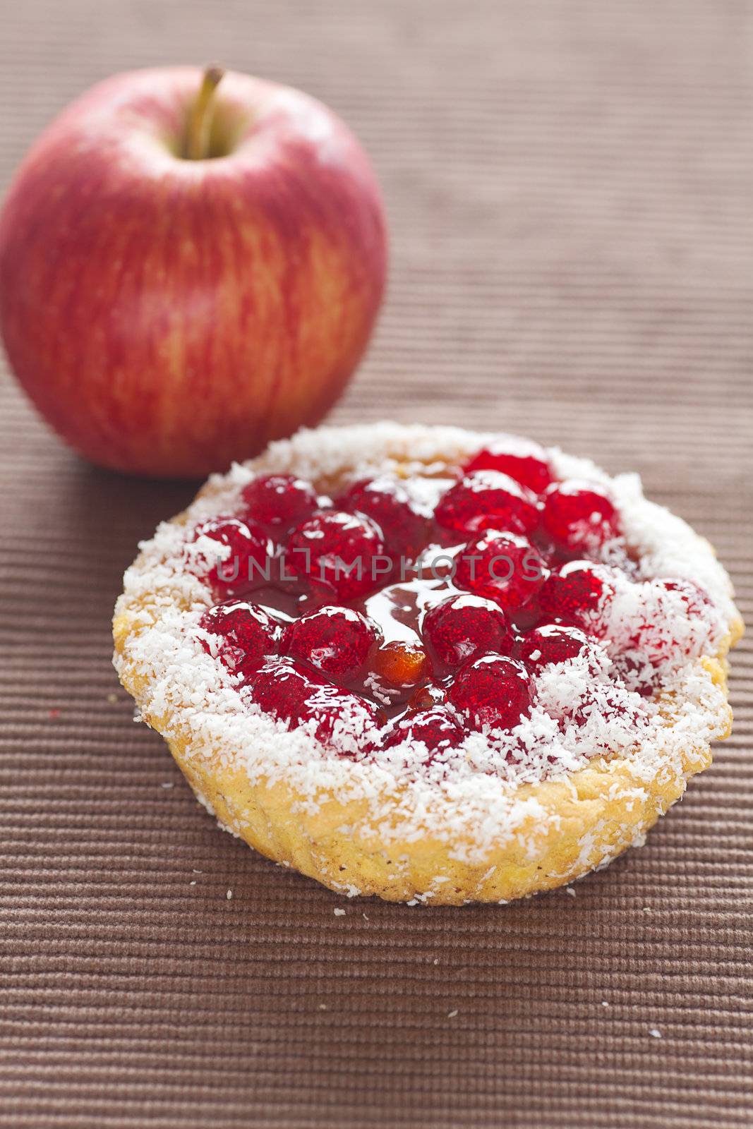 beautiful cake with berries and apple on brown mat