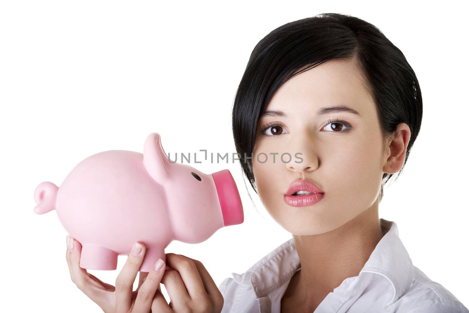 Happy business woman with her savings in piggy bank