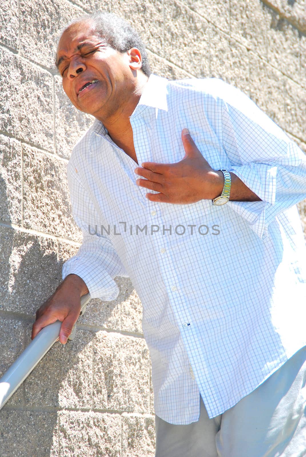 African American male having chest pains outside.