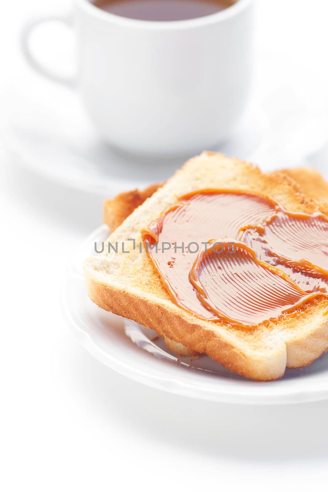 tea and toast with caramel isolated on white