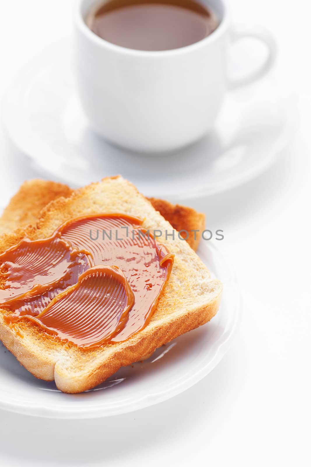 tea and toast with caramel isolated on white