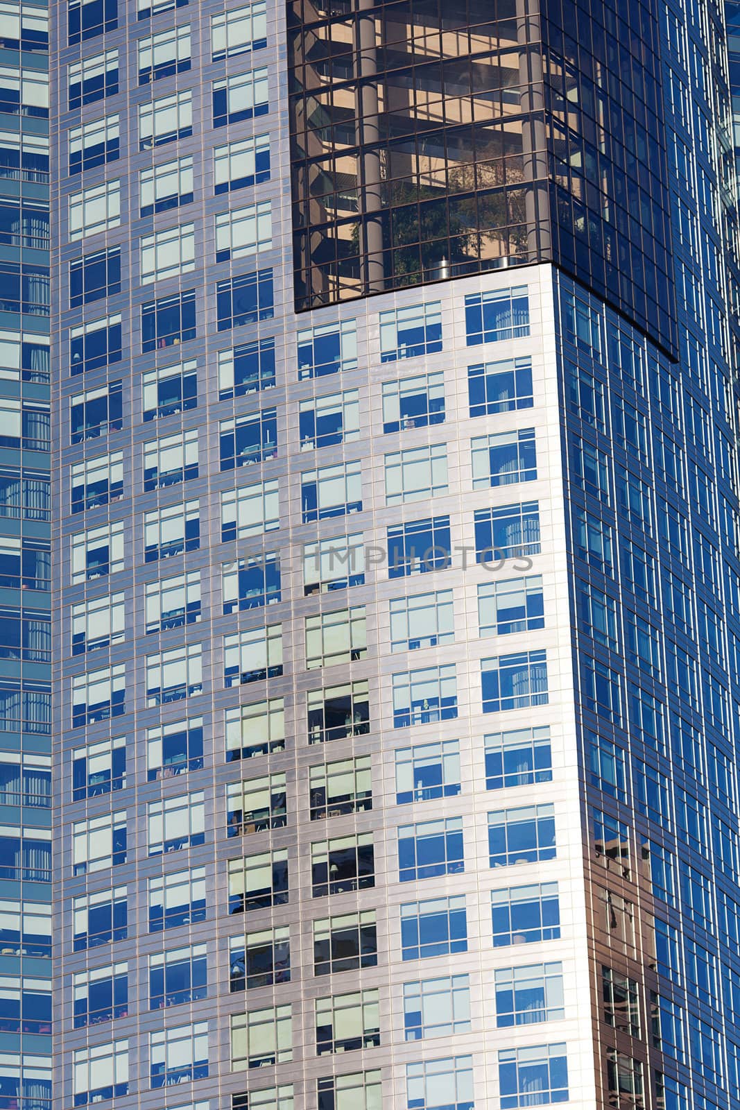 Beautiful modern office building against the blue sky by jannyjus