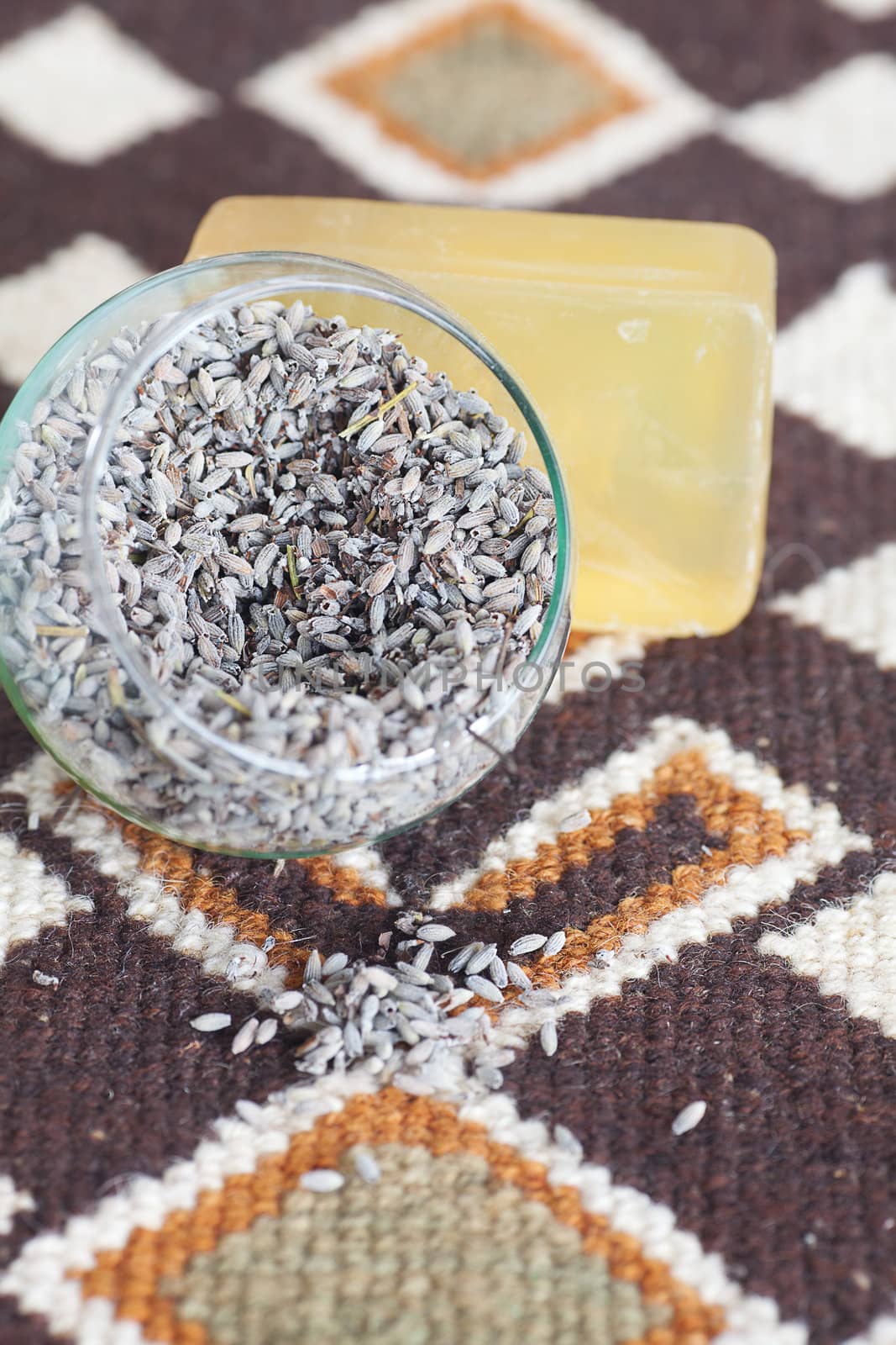 lavender in bowl and soap on ethnic mat