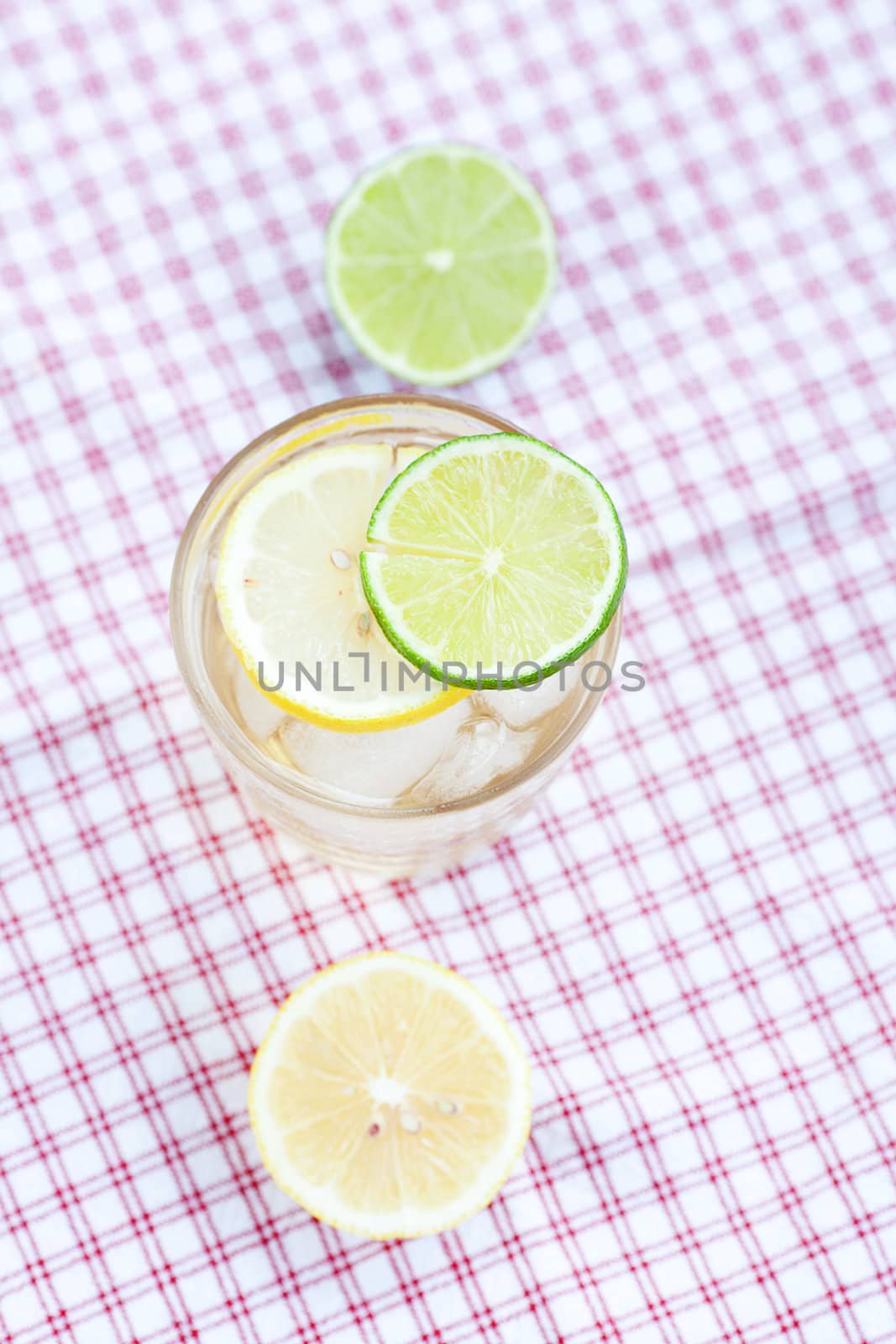 water with lemon and lime in a glass with ice