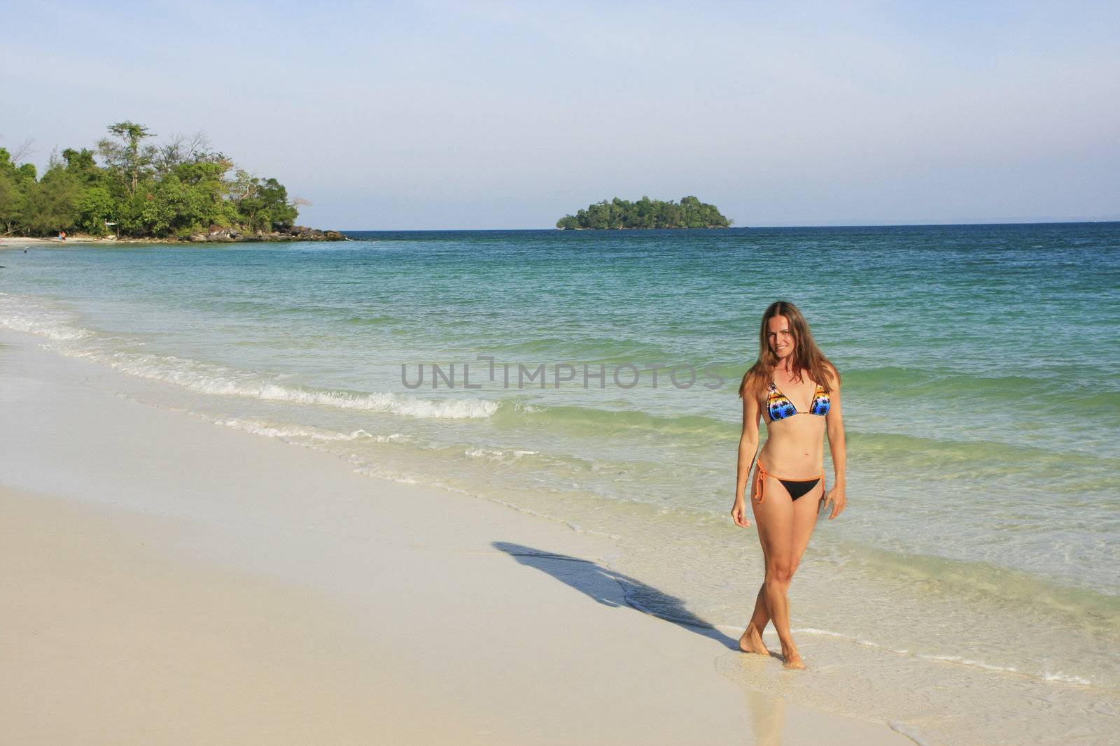 Young woman walking on a beach of Koh Rong island, Cambodia, Southeast Asia