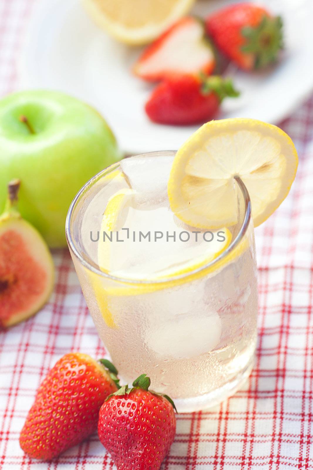 cocktail with ice,lemon, fig,apple and strawberries 