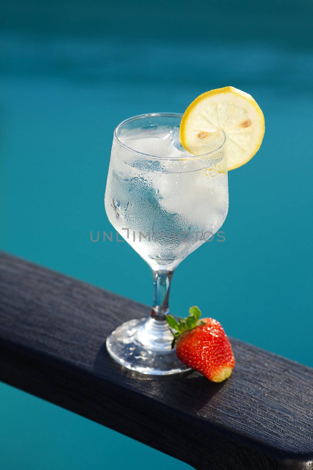 Swimming pool, lounge, a wine glass with ice, lemon and strawber by jannyjus