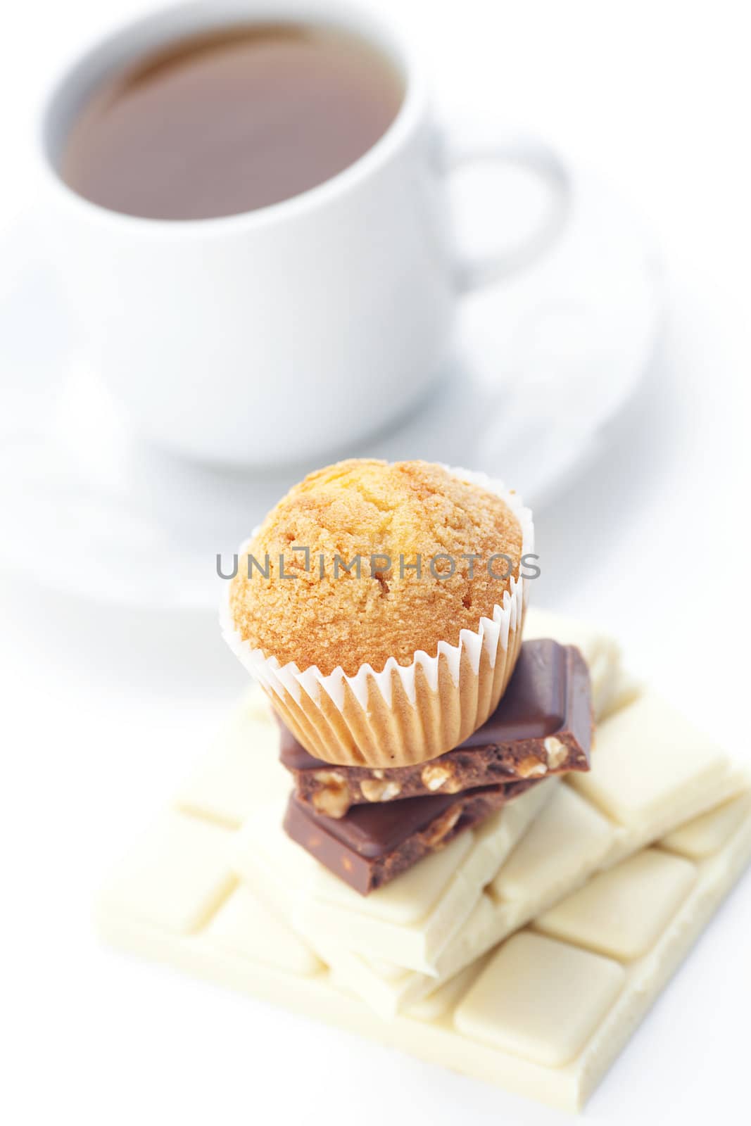 bar of chocolate,tea and muffin isolated on white