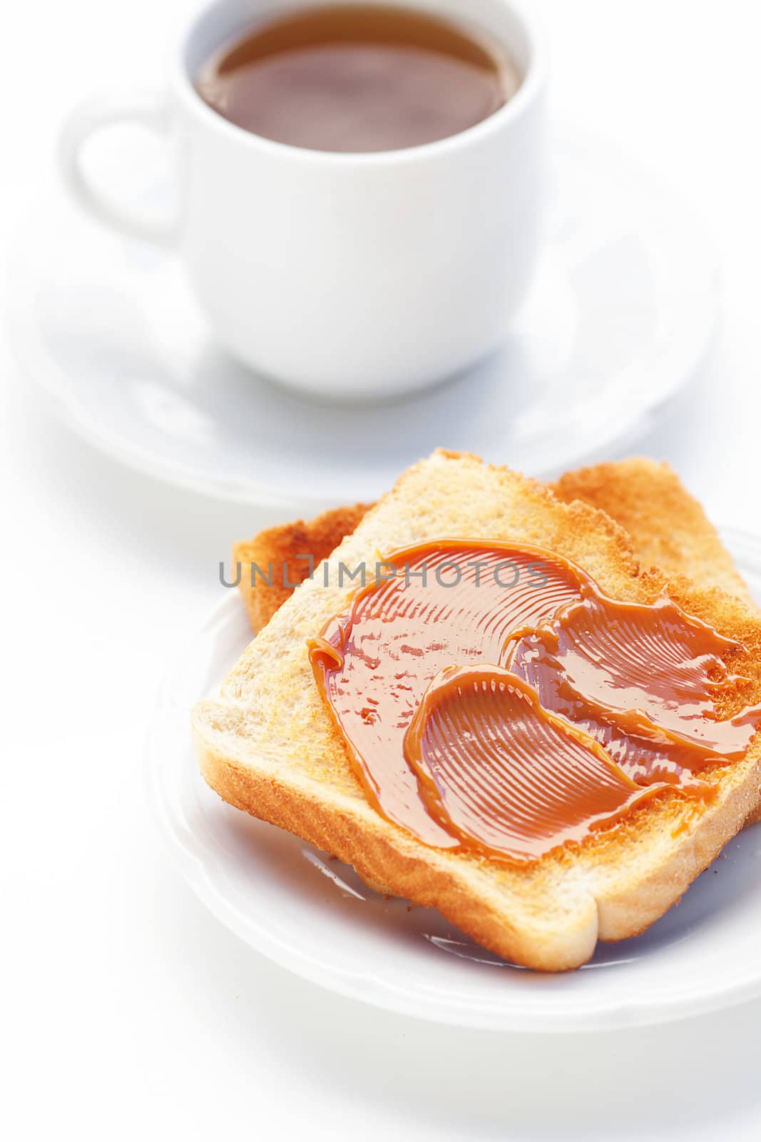 tea and toast with caramel isolated on white