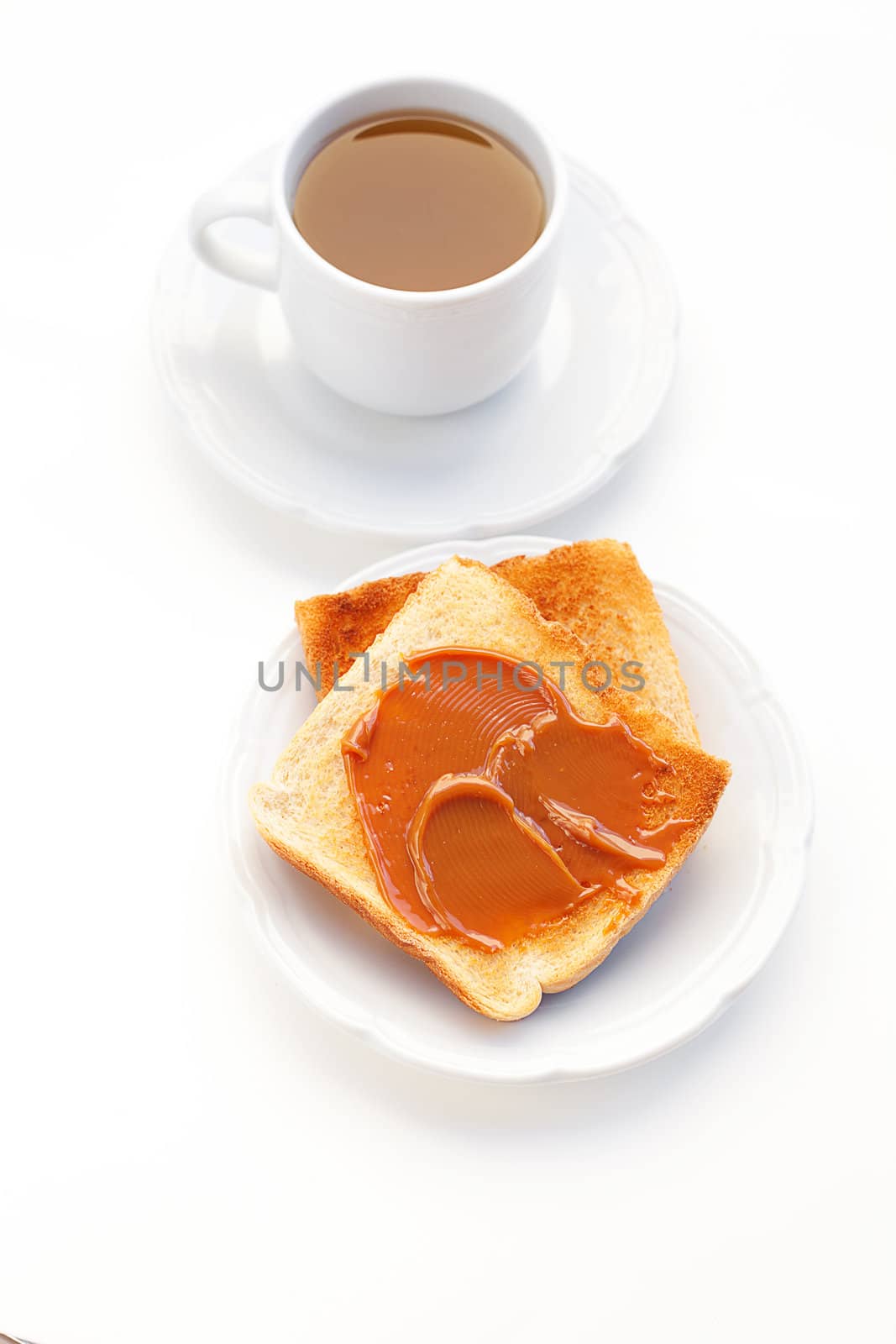 tea and toast with caramel isolated on white by jannyjus