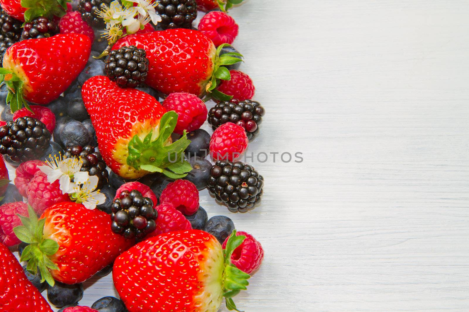 Berry over white  Wood. Strawberries, Raspberries, Blueberry