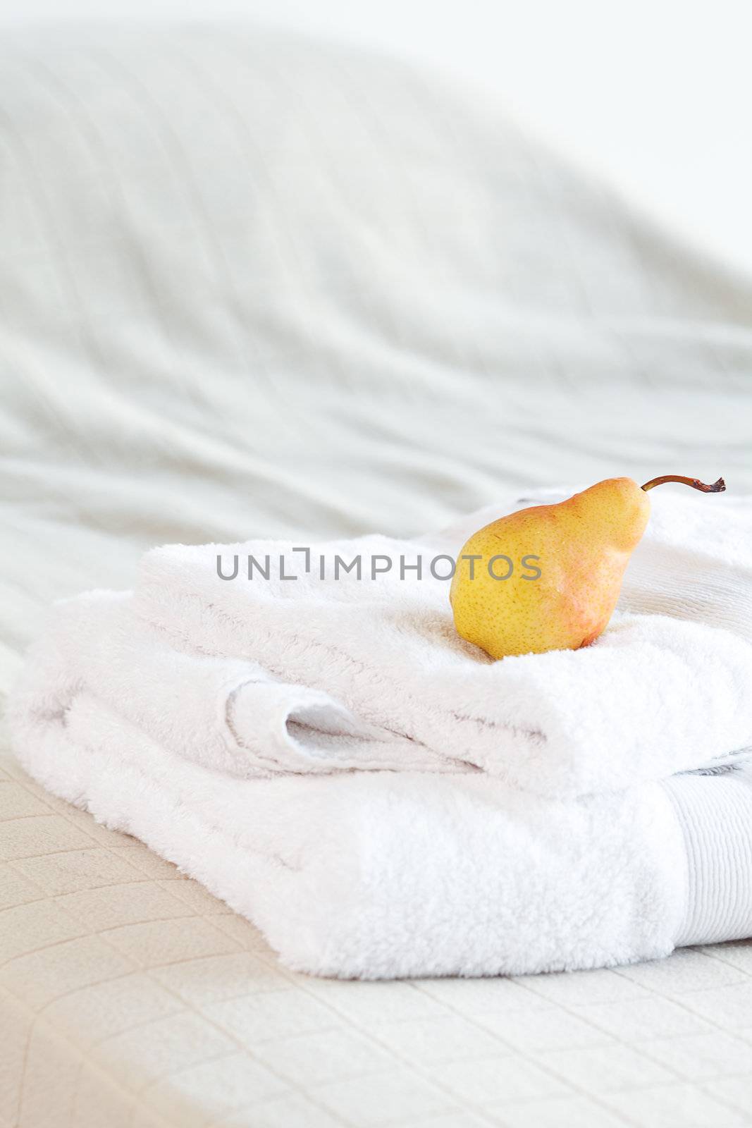 pear lying on towels on the bed 