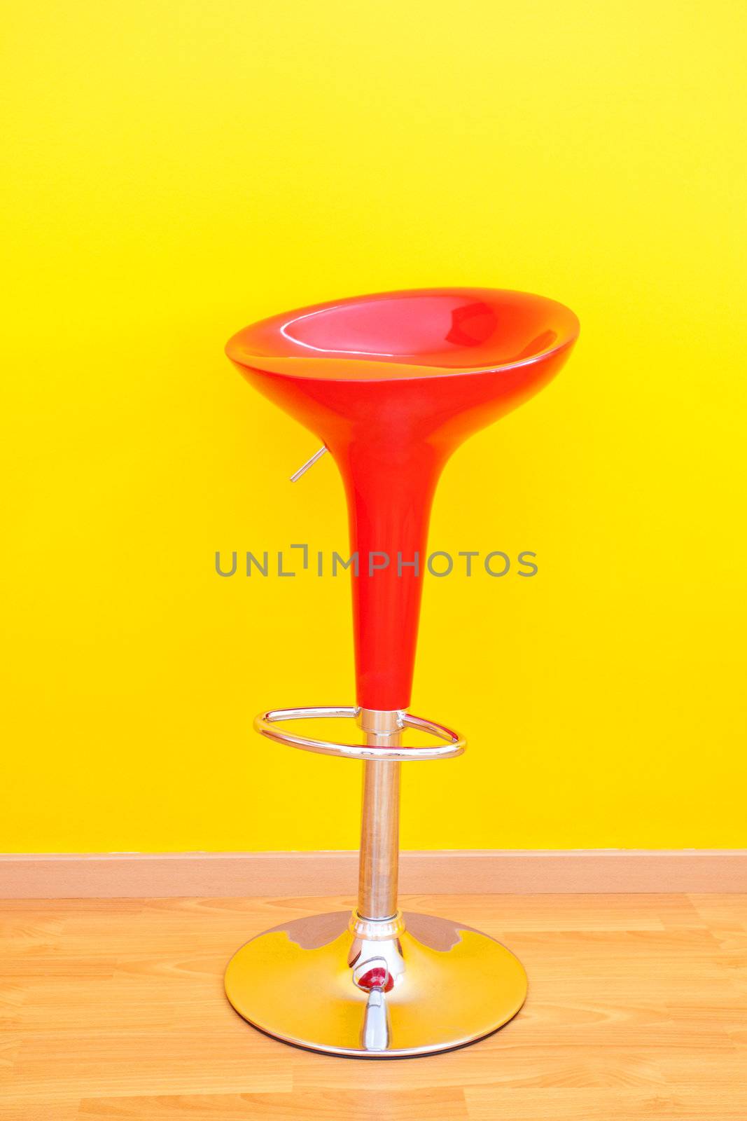 bar chair against a yellow wall in the apartment