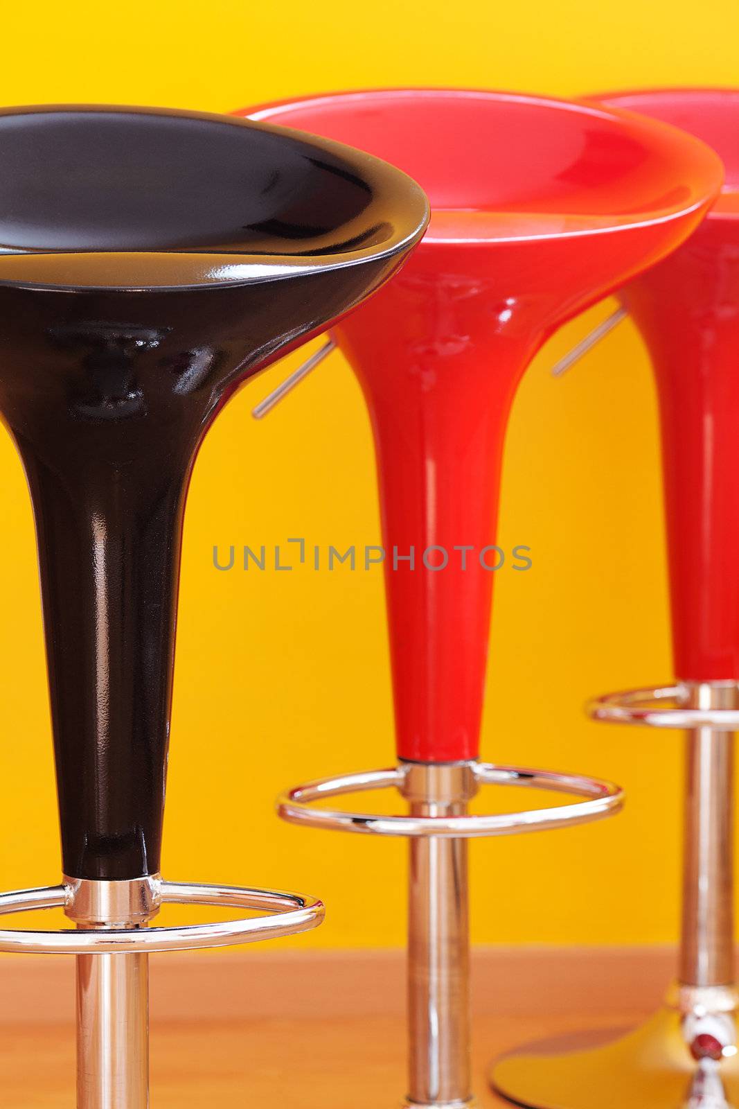 bar chair against a yellow wall in the apartment