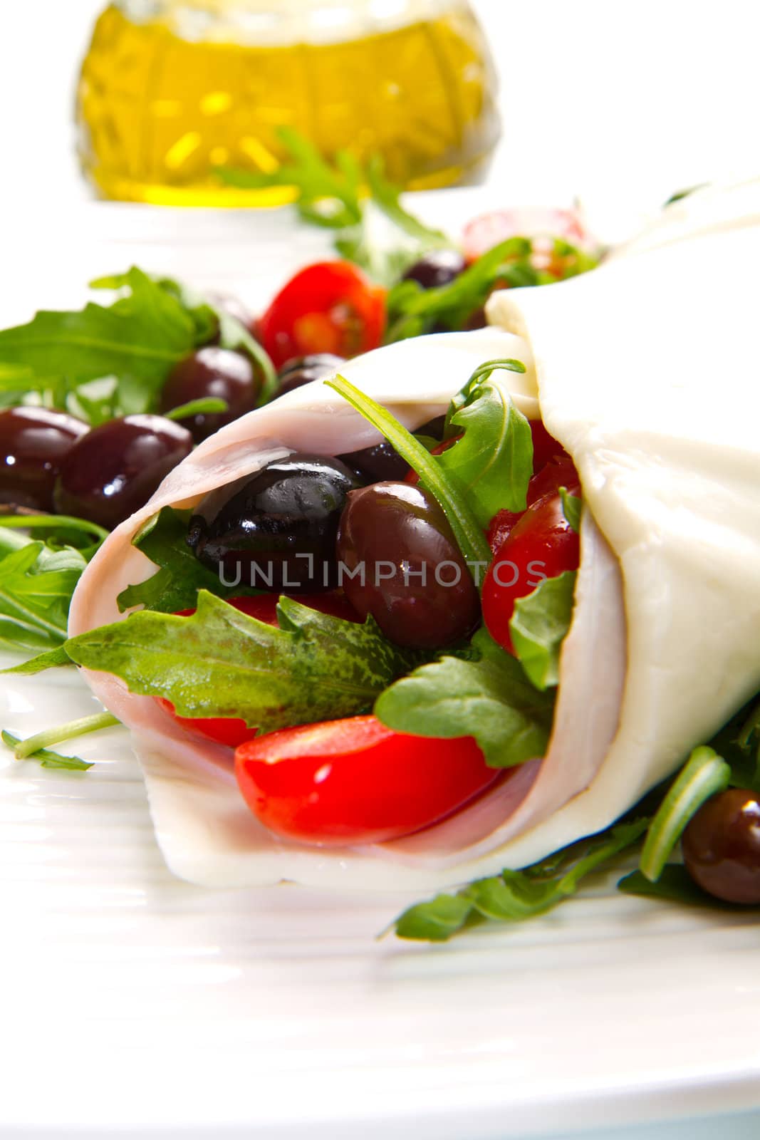 mozzarella roll with tomatoes,olives and salad