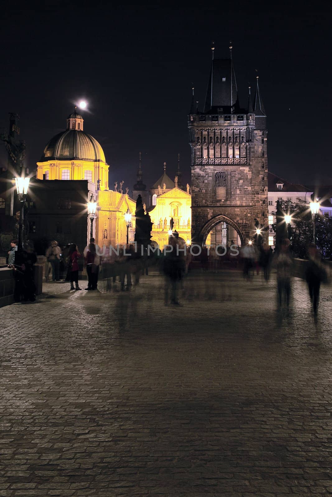 Vertical view of Prague by night on a bridge