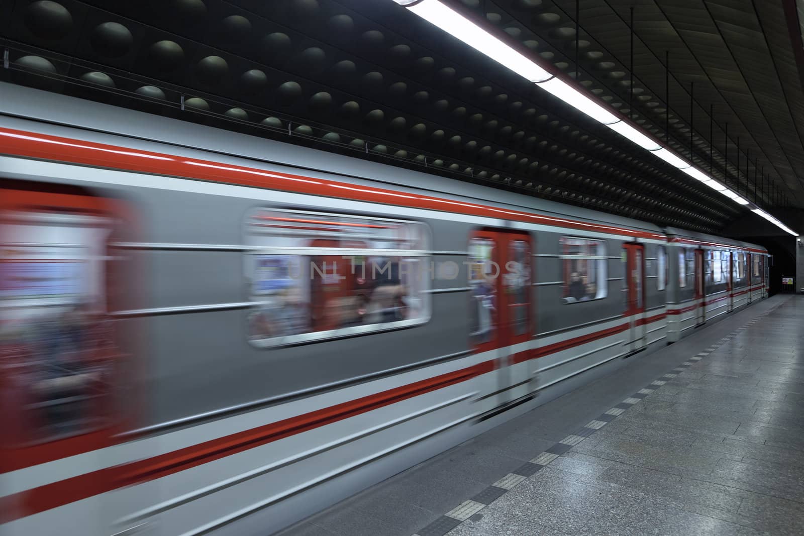 Train arrives on station at Prague subway. 
