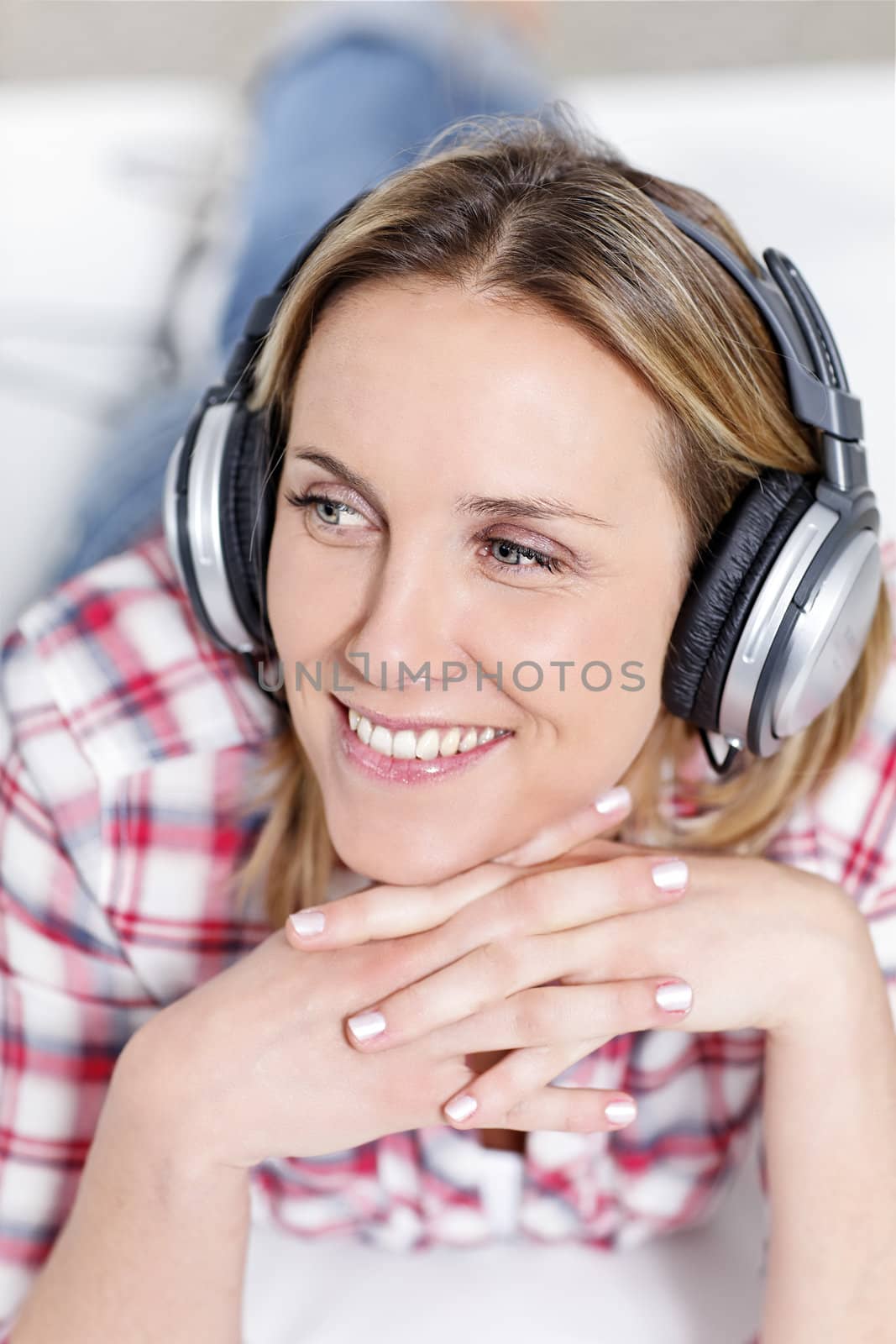 youngblond woman listening music with headphones