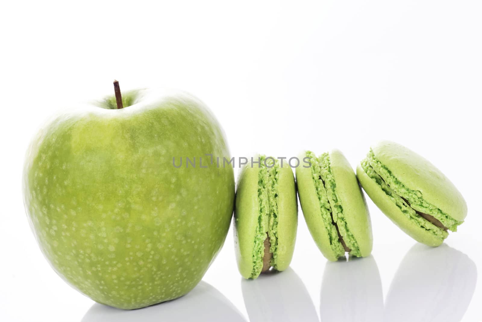 apple with macaroons on white background