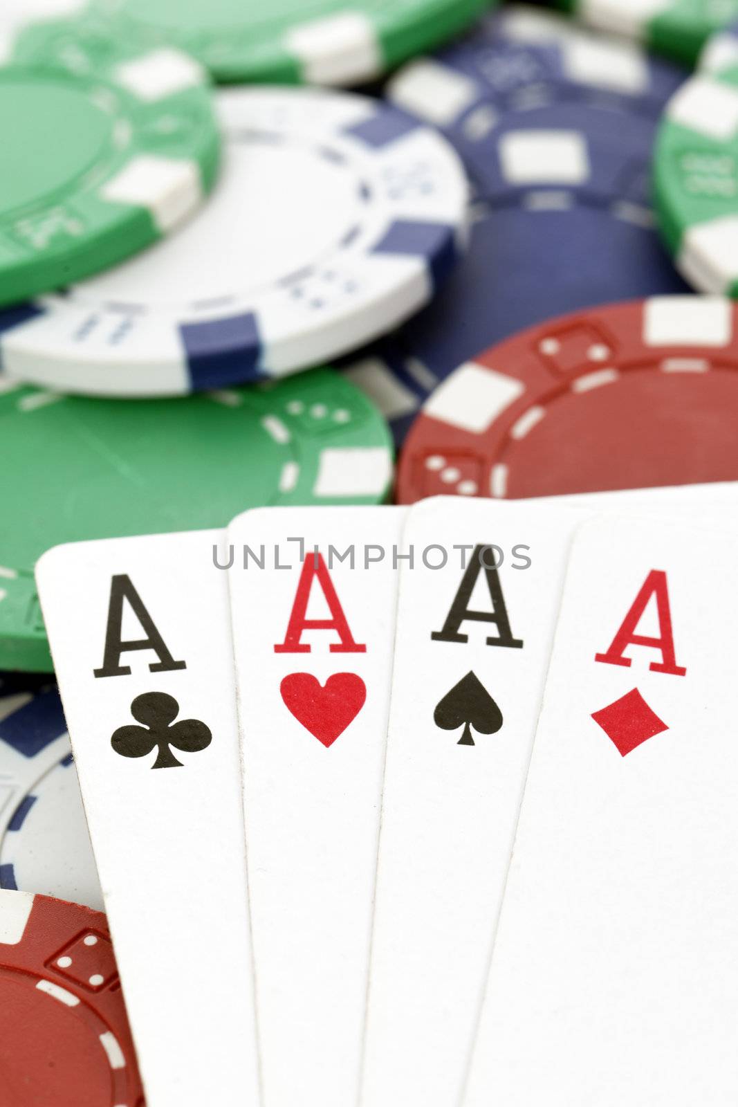 four aces with chips on a poker table