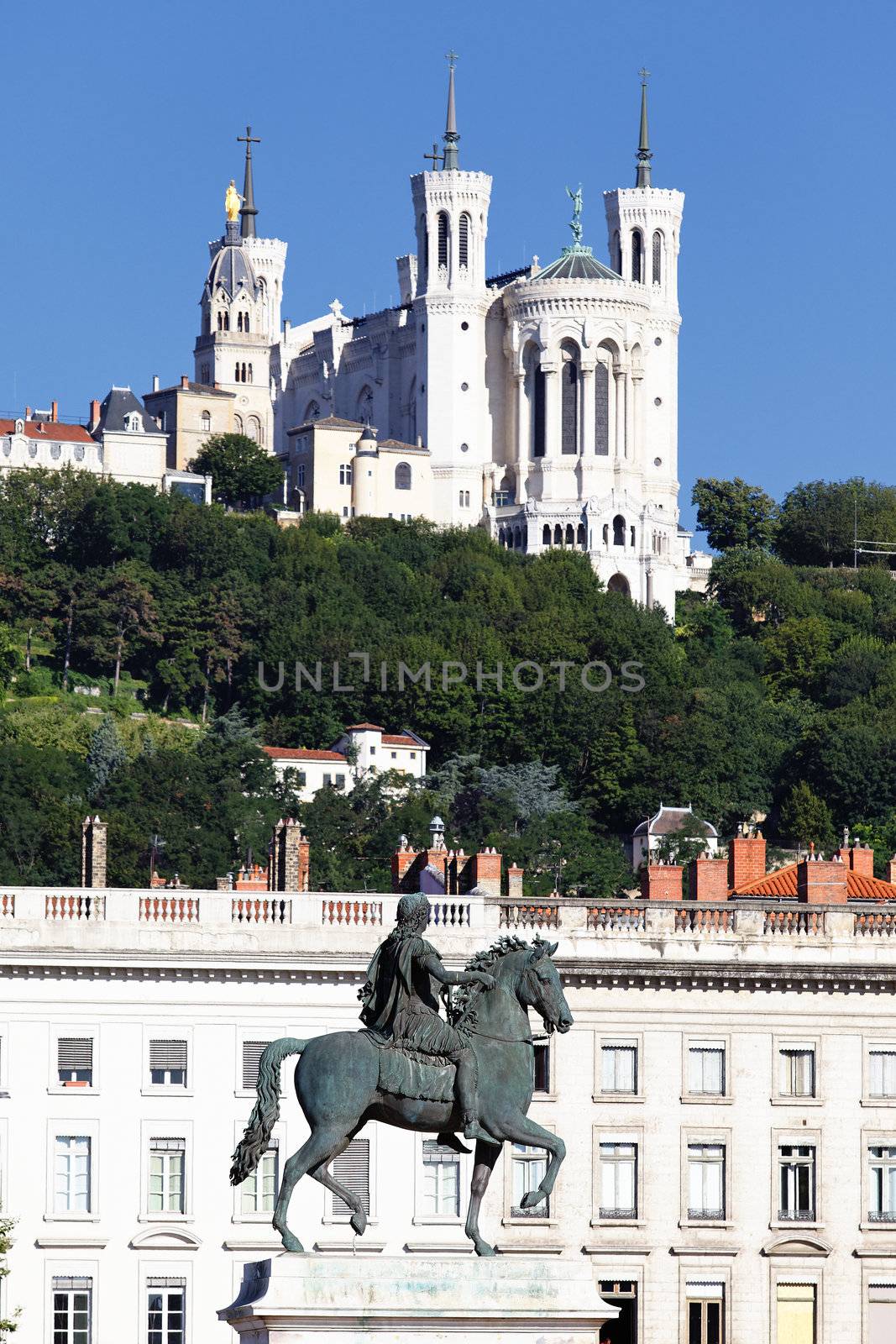 statue of Louis XIV and Basilique Fourviere on a background 