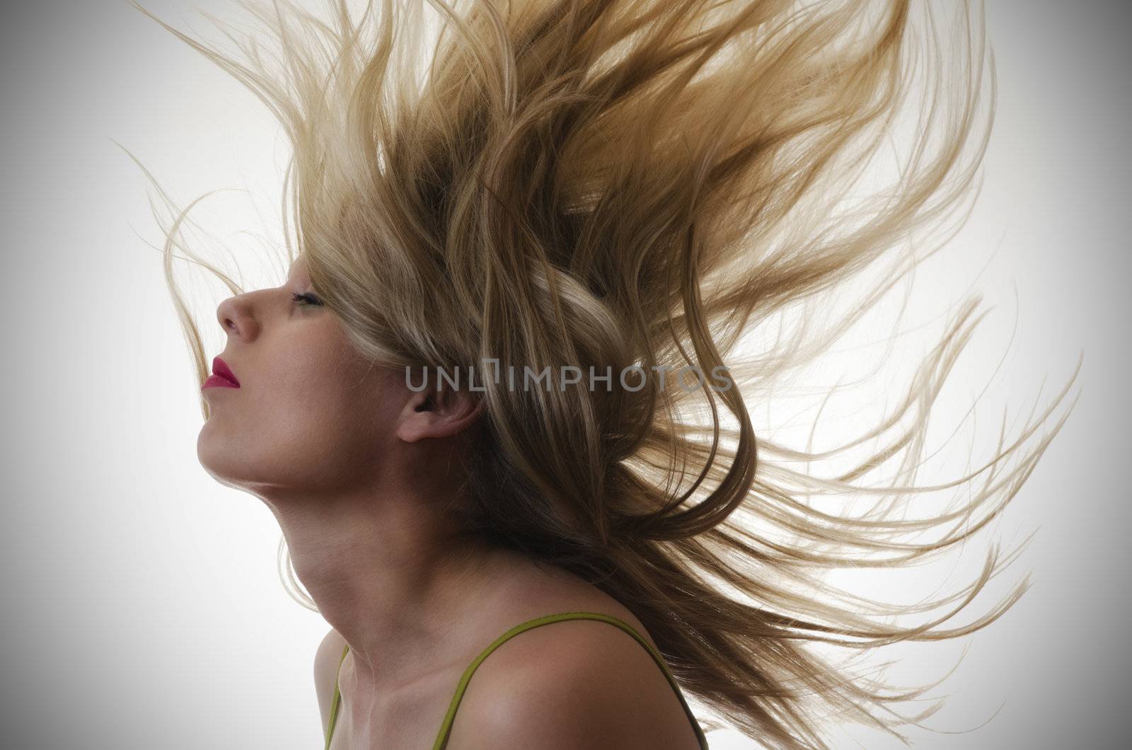 portrait of a woman with hair flying in the air