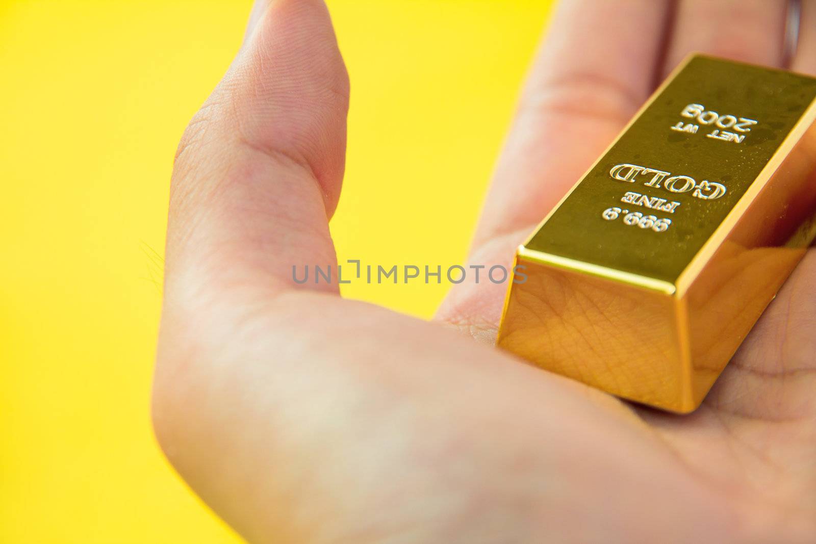 hand holding Gold Bar