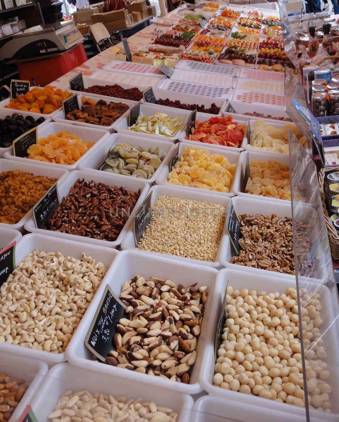 A variety of fruits and nuts being sold on a street market stall