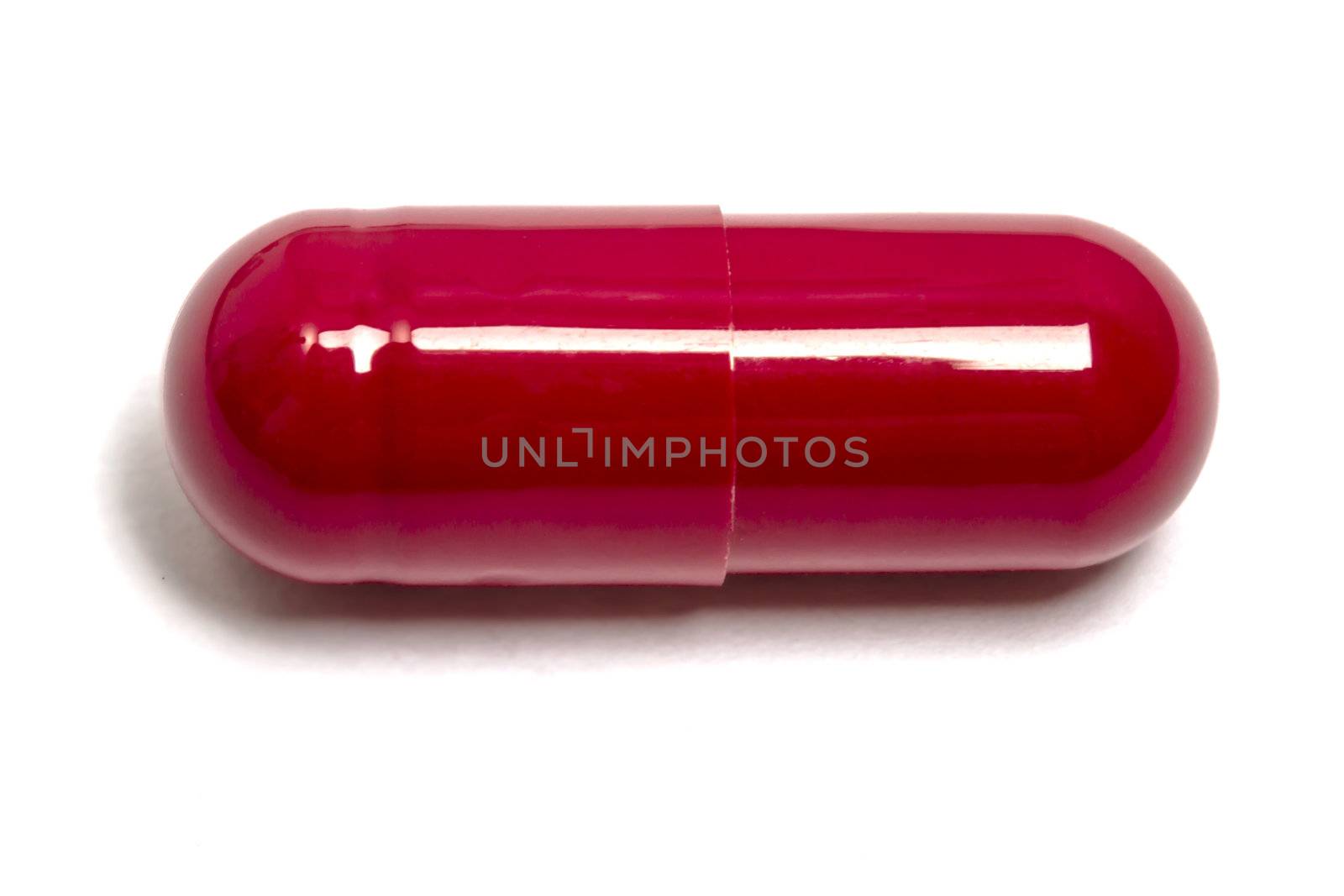 Red capsule isolated on white background 