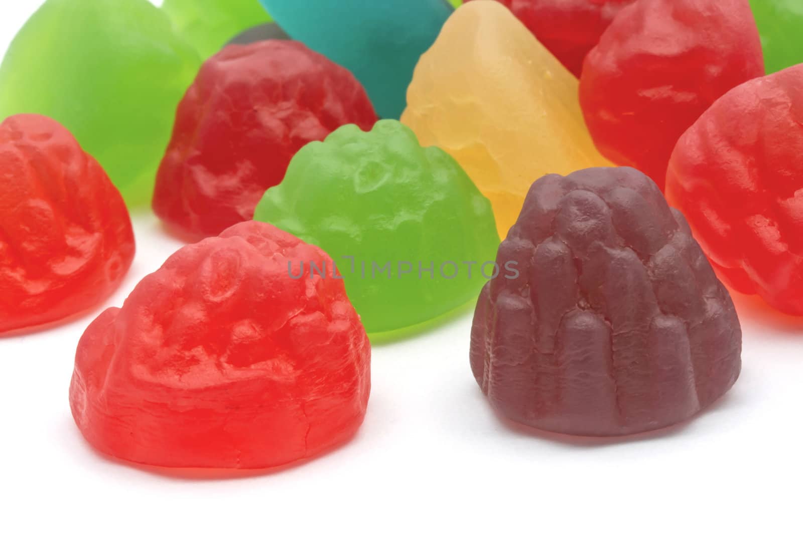 Colorful fruits candy closeup on white background 
