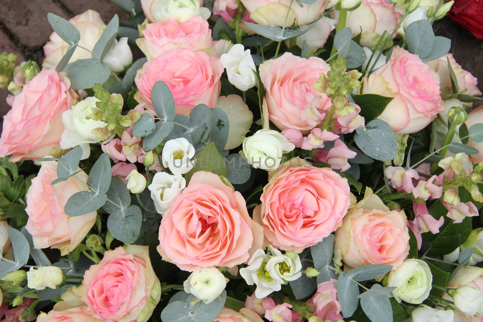 Pink roses and eucalyptus in a pink white wedding flower arrangement