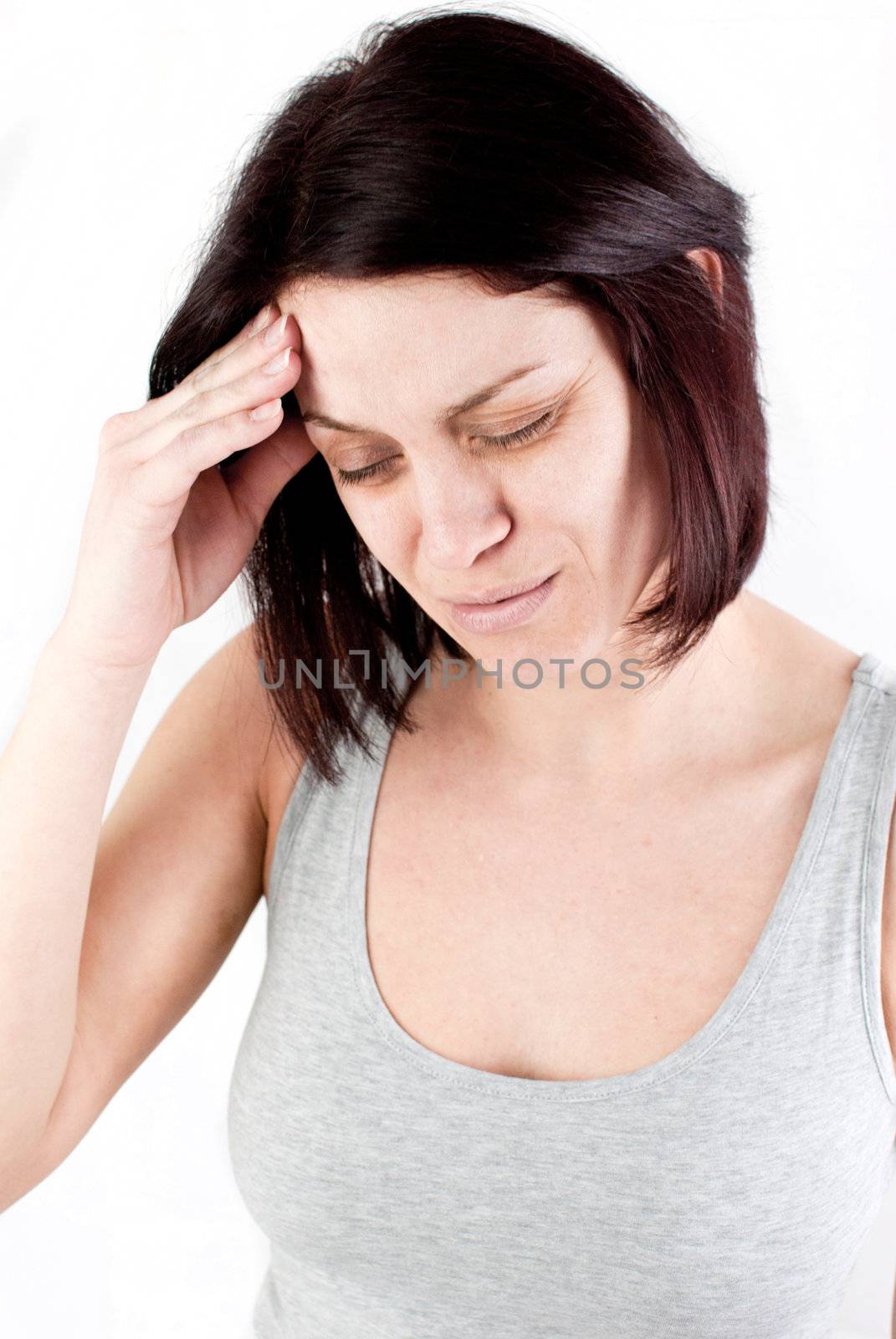young woman with headache making massage to avoid pain