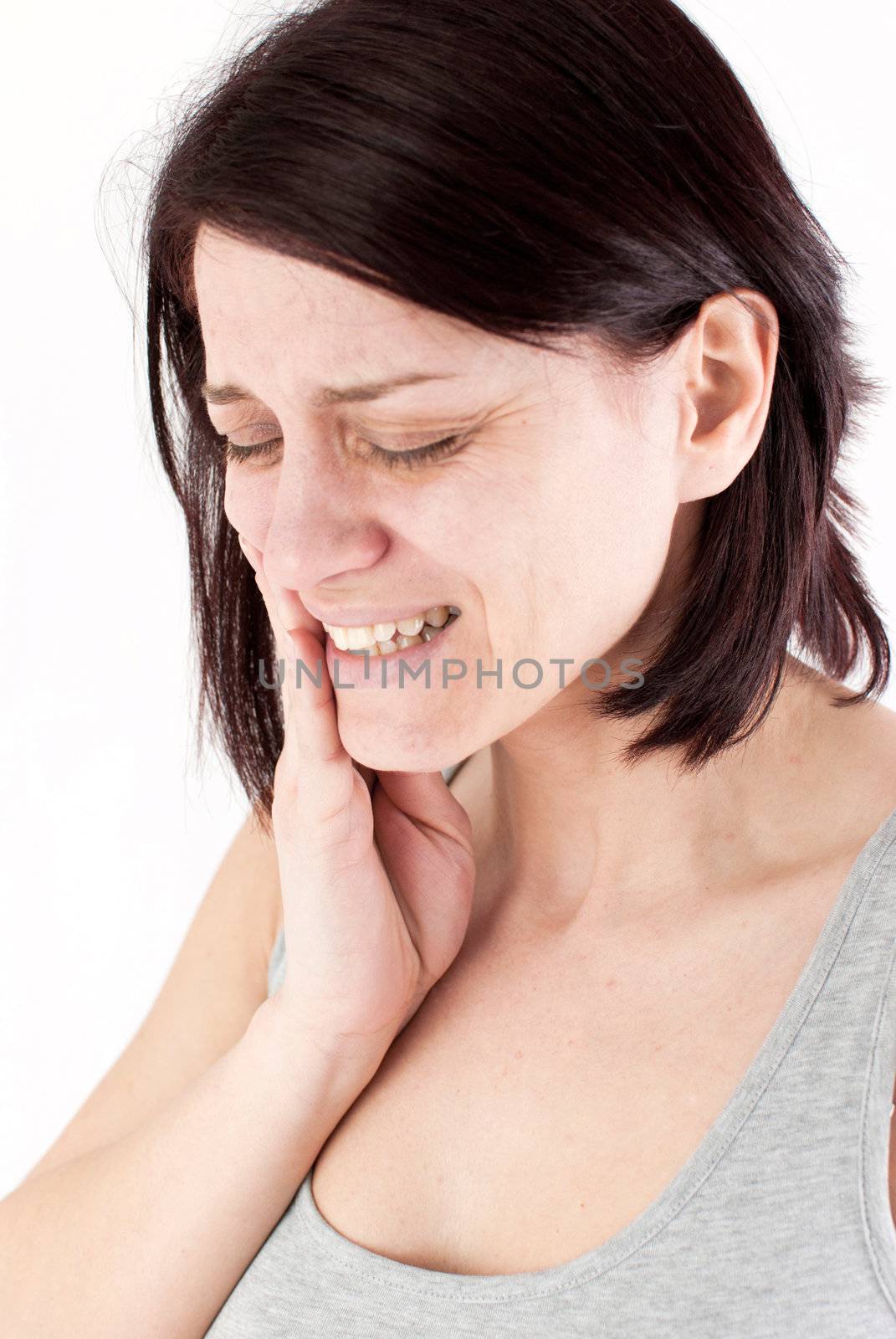 young woman with tooth ache making massage to avoid pain