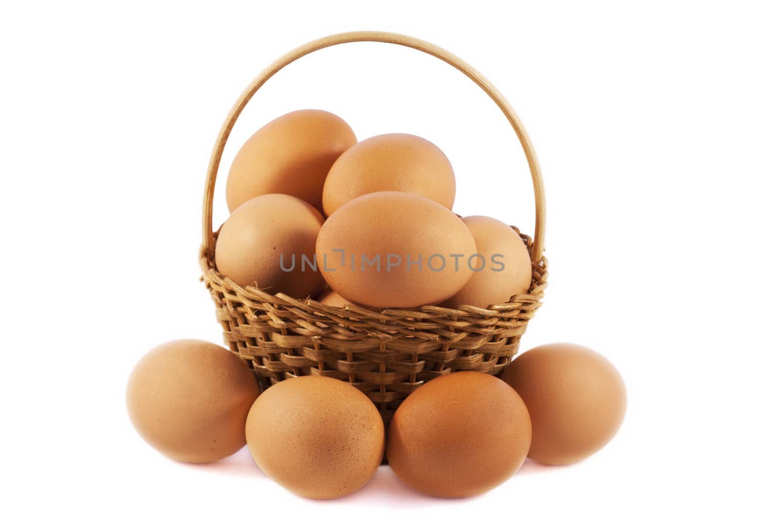 Eggs in a basket over white isolated background